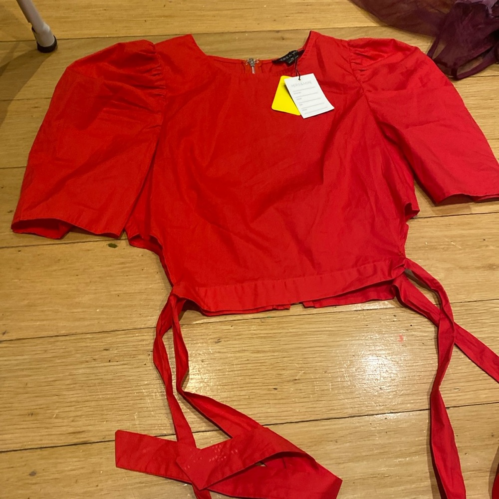 Hers&mine Woman’s red top with buff sleeves and tied sides